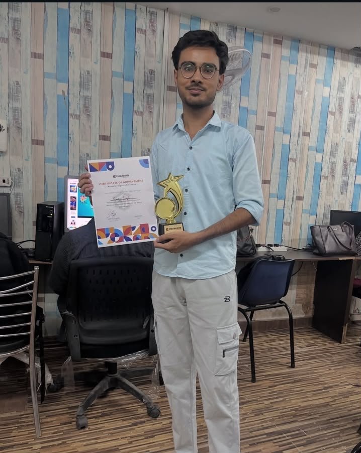 Student holding a course completion certificate and trophy