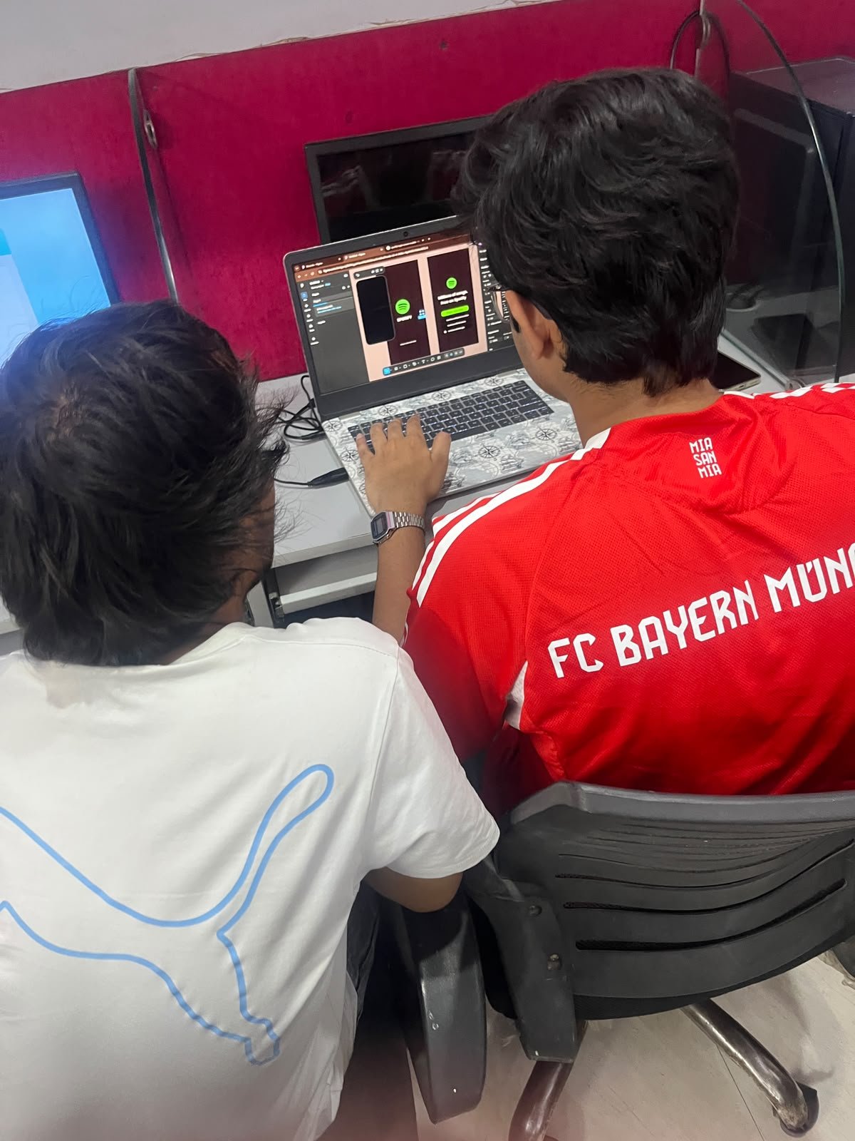 Students working on a video editing project on a large screen